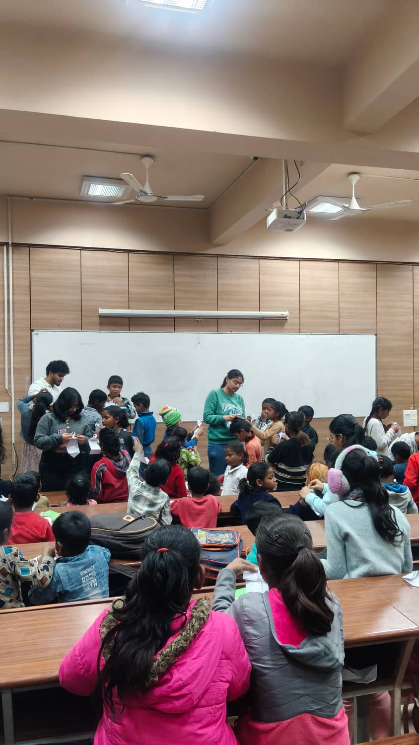 Triman helping children with a hands-on classroom activity
